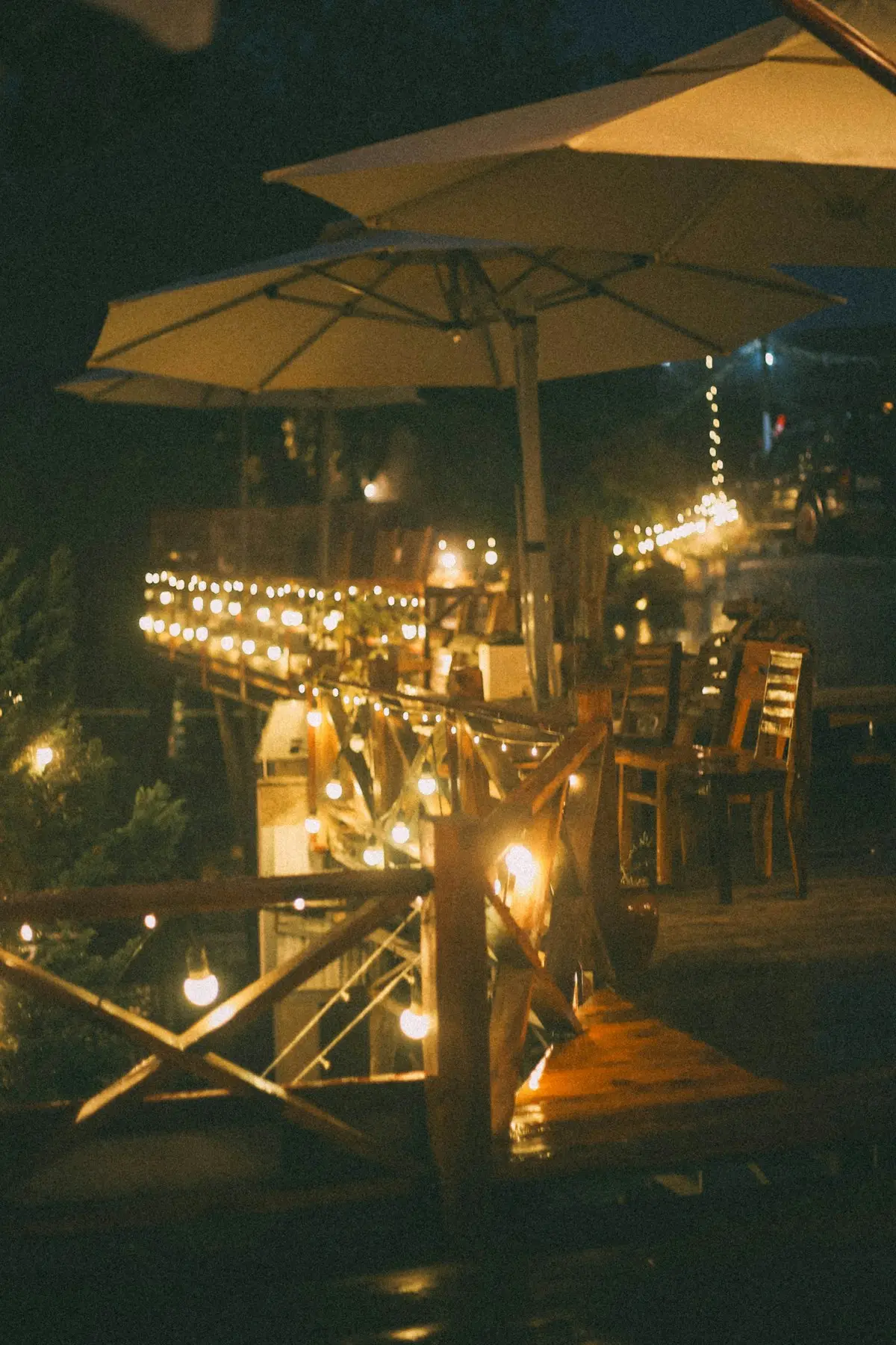 String lights over café tables at night